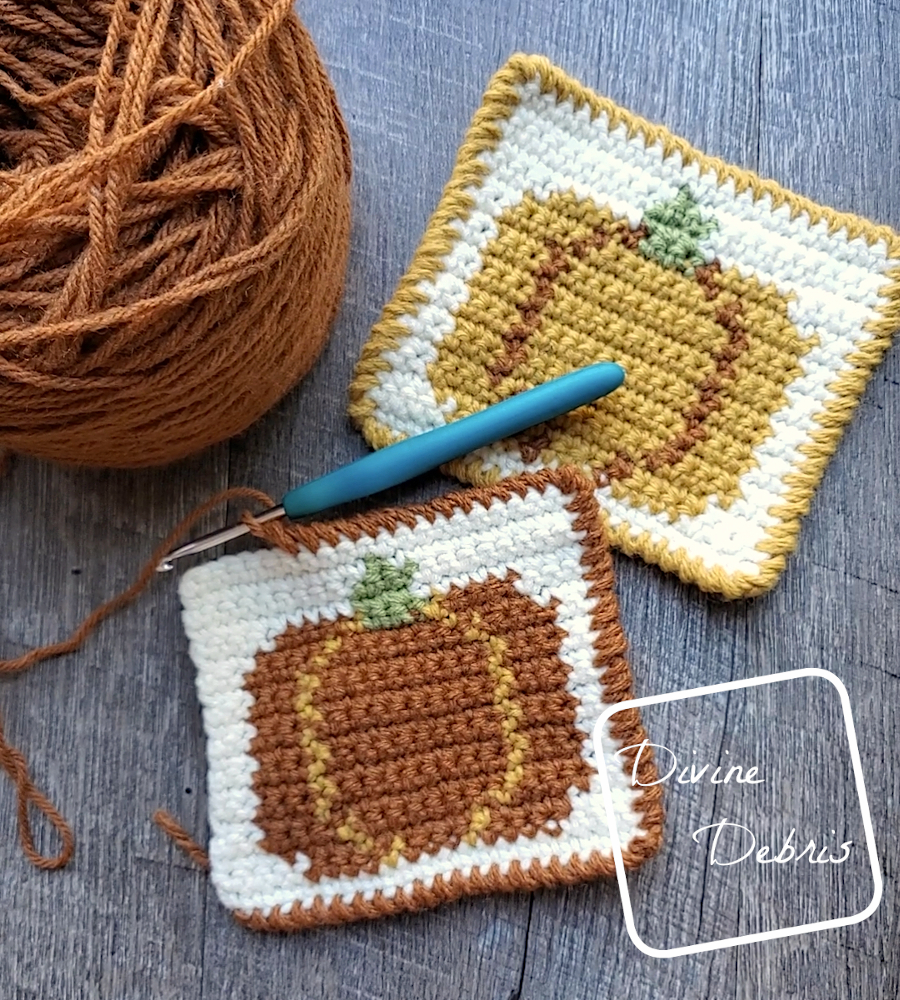 [Image description} top down view of 2 Fall Pumpkin Coasters on a wood grain background, the front one doesn't have  a completed border.